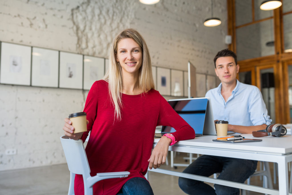 Woman smiling and holding coffee cup, Force Protection expert team and insights