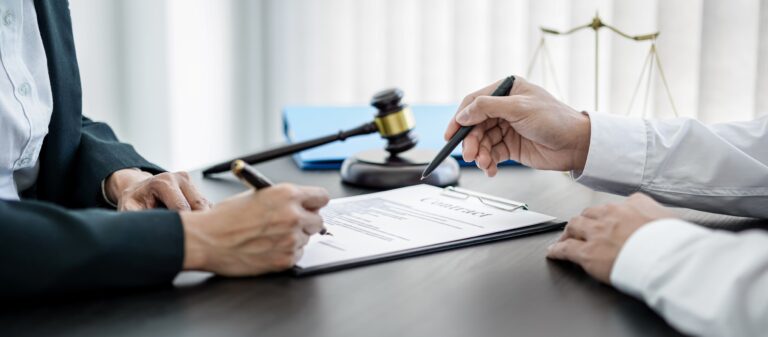 Lawyer consulting with client over legal documents and gavel