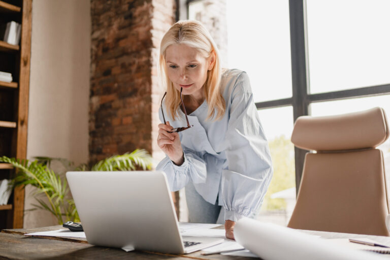 Woman working on laptop at desk, security lifestyle advice and tips