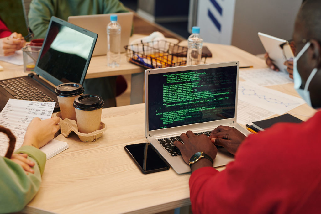 Team collaboration and security insights with laptop displaying code.