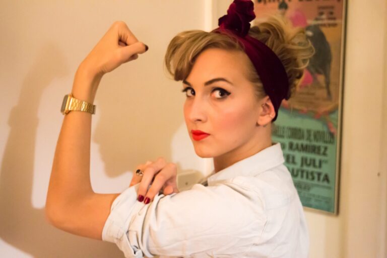 Empowered woman flexing arm, tribute to women in male-dominated industries, career advice.
