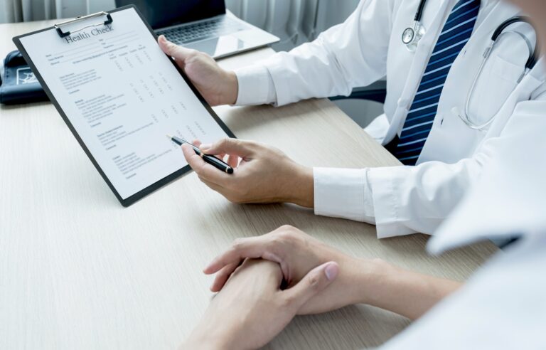 Doctor explaining health examination report and checklist for business incident planning.