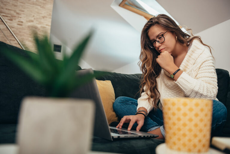 Woman studying on laptop in quiet space, security advice and resources.
